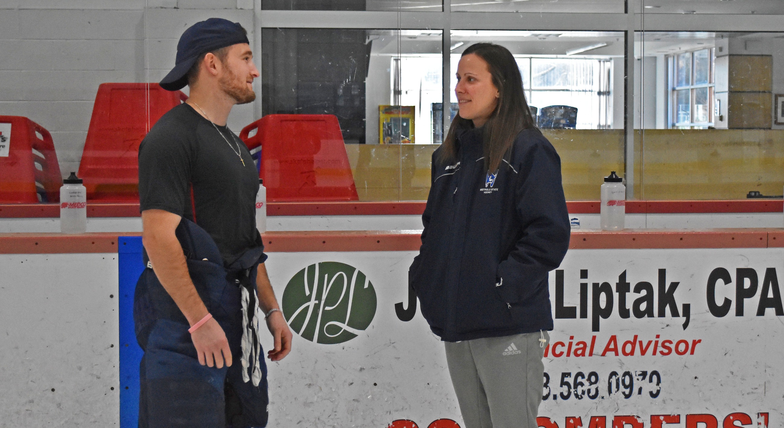 Justin Collins chats with trainer Katie Sylvain before a practice.